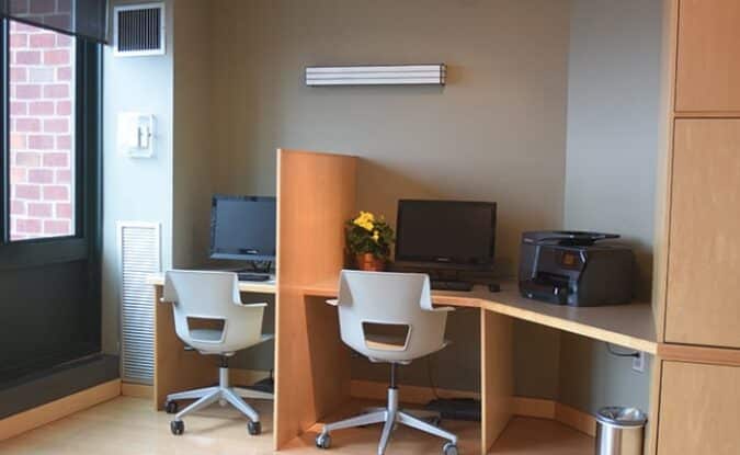 picture of desks with office chairs and computer monitors inside of Park Place business center
