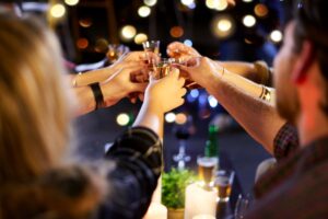 Cropped shot of group of friends having fun at nightclub, concept of nightlife, friendship, and joyful social moments