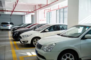 Cars parked in a bright indoor parking garage, highlighting the convenience of garage parking for apartment residents.