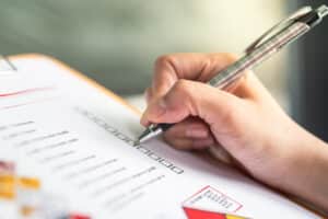 Prospective renter using a checklist to compare properties and track amenities